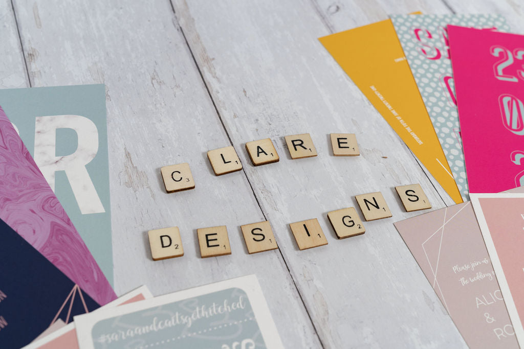 Copyright ERK Studio. Flatlay of several bookmark-style wedding invitation/save the date designs. All designs copyright of Clare Designs.