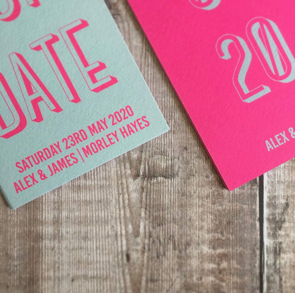 Close-up of the textured card. Bookmark-style wedding invitation/save the date. The overall style is typographic and bold.